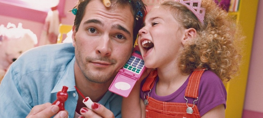 Daughter-playing-with-father-with-hair-curlers-and-nail-polish-1074x483
